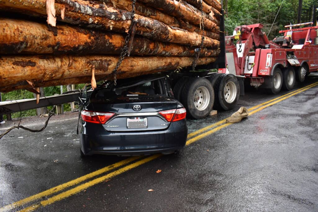 Log truck automobile collision