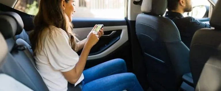 Young girl on phone in vehicle
