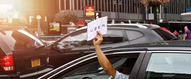 uber driver holding up sign