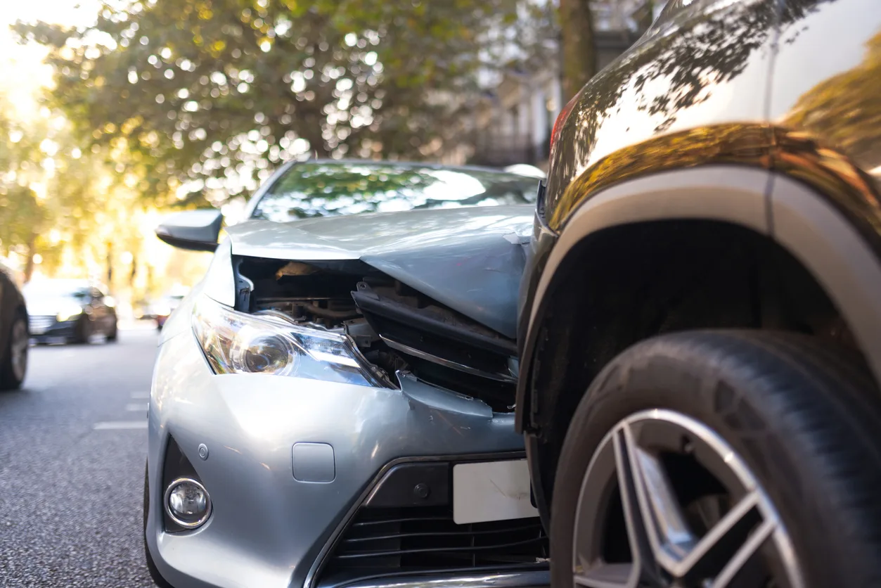 Close-up of two cars damaged in road traffic accident, no people